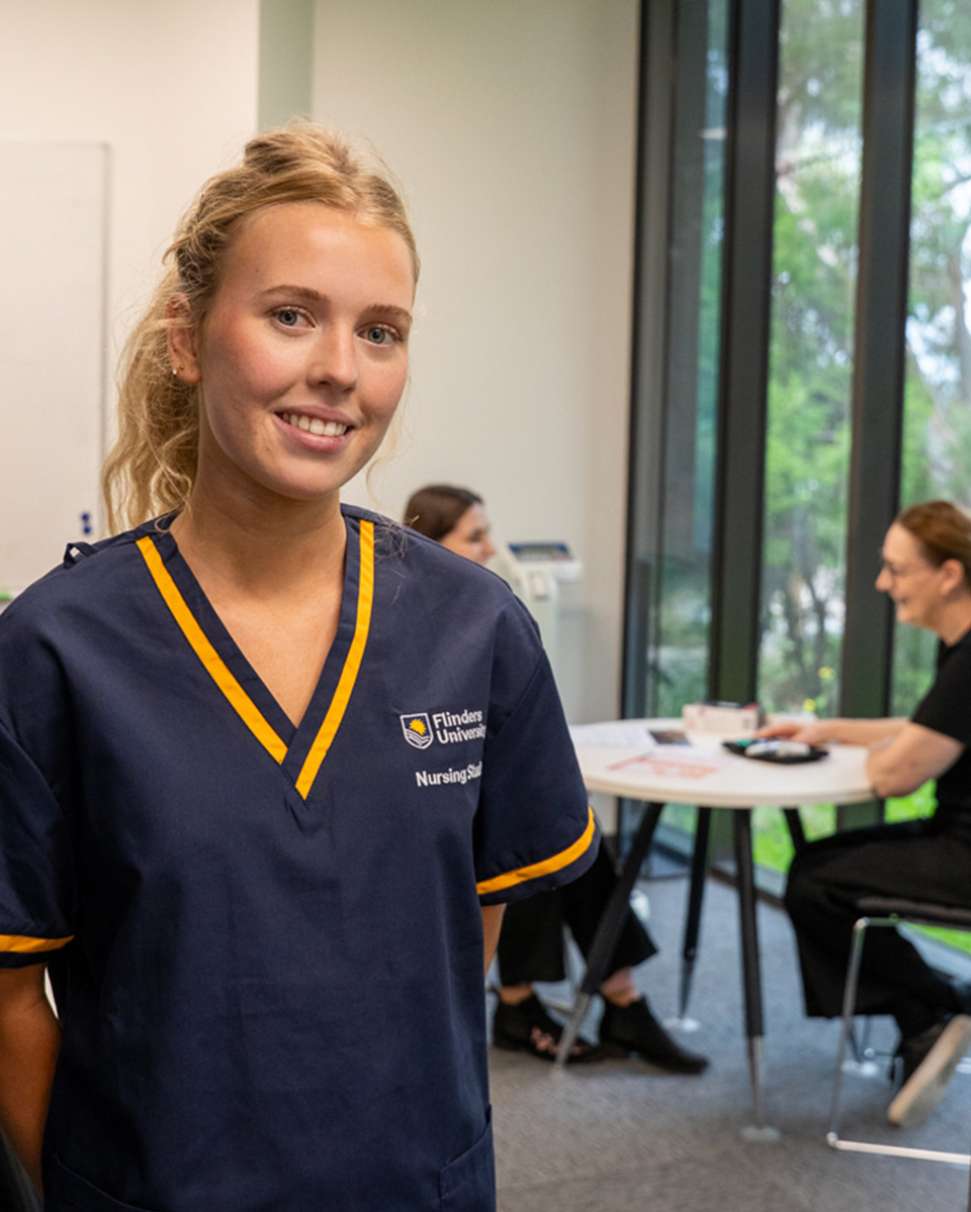 Flinders Nursing student with diabetes patient sitting and smiling in background