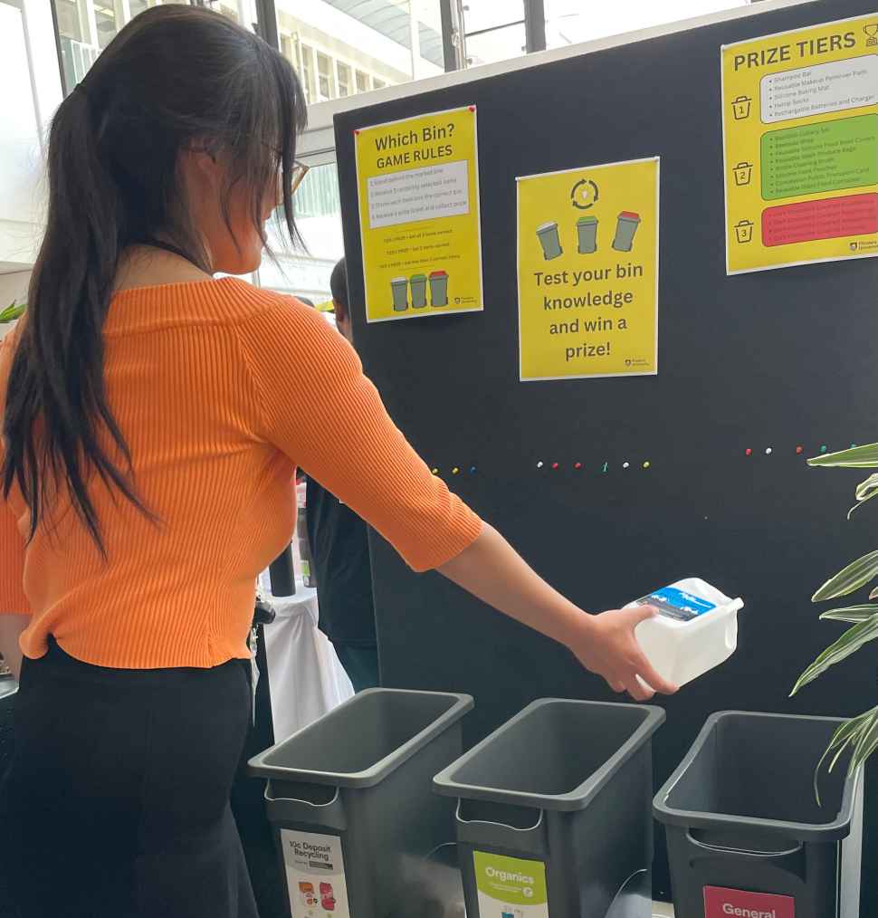 image of girl playing In Which Bin Game - selcting which bin her waste should go in
